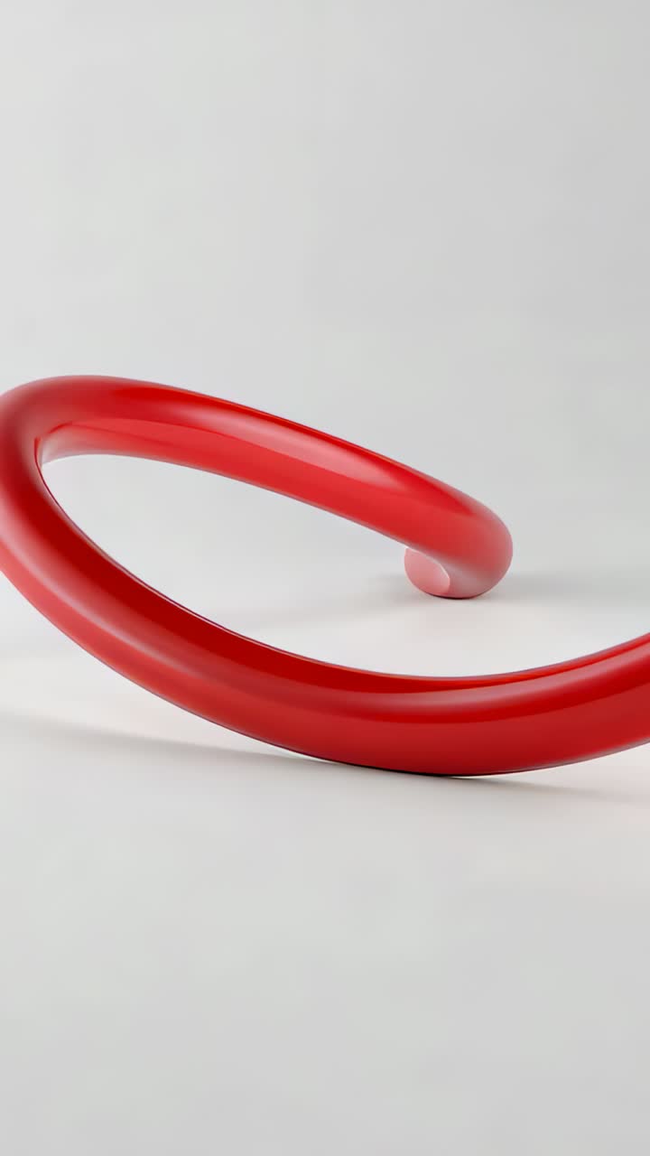 Vertical video: Play, shiny red tube sweeping up over pale set, showing small pale sphere and shine