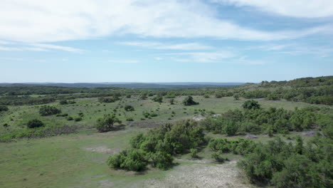 aerial view moving over the hills of the texas hill country