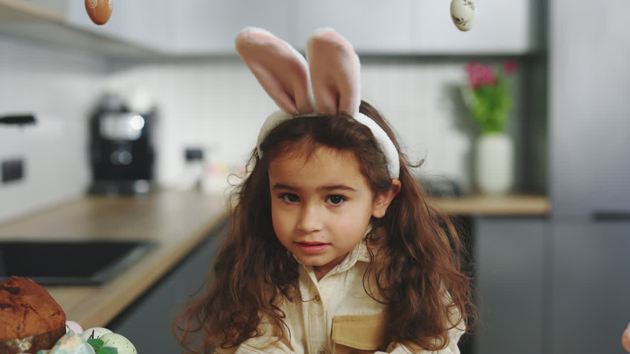 Little Girl in Bunny Ears in the Kitchen during Easter
