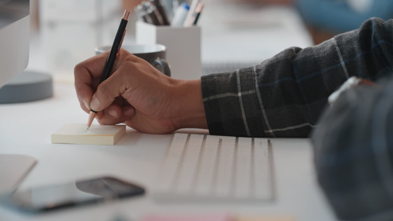 close up hands typing on computer keyboard browsing online sending emails working on project writing notes at office desk