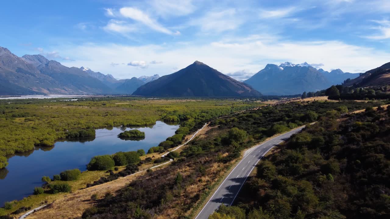 AERIAL Shot of a Road cutting though a Stunning Mountain Landscape in Glenorchy, New Zealand