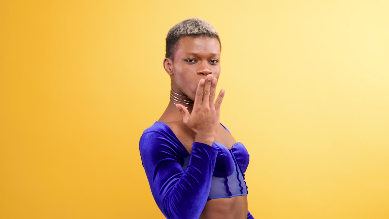 Confident Young Person Posing and Smiling on Yellow Background