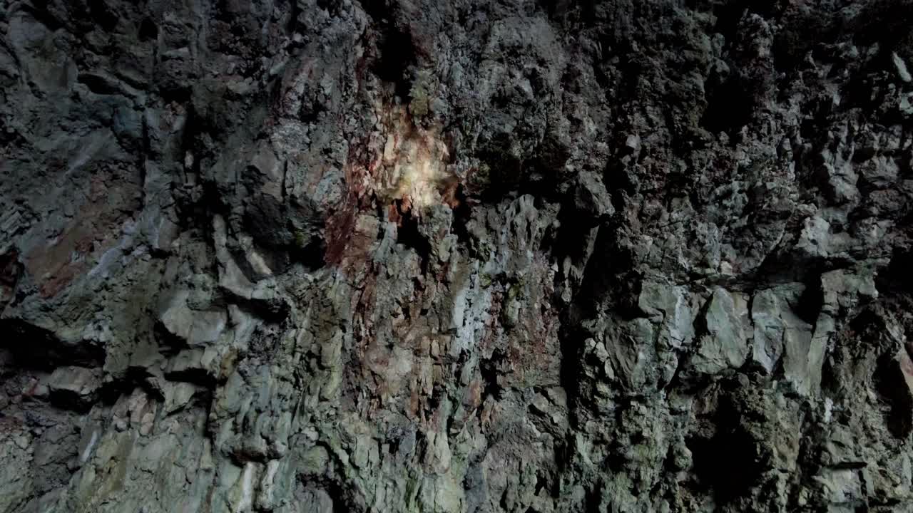 A ray of light reflecting in the water of a sea cave, creating a mysterious and surreal projection on the rocky wall, Vis island, Adriatic Sea, Croatia