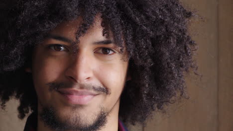 close-up portrait of a young man with curly hair