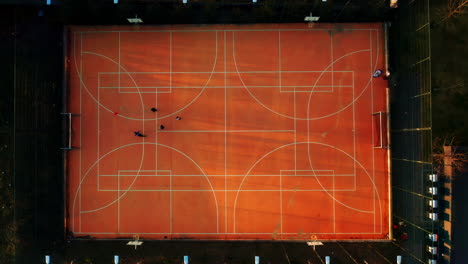 top-down shot of children playing football on a multi-purpose court