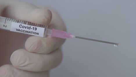 syringe in medical set up with corona virus vaccine, close up shot