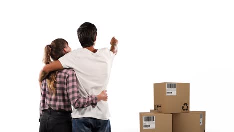 Animation-of-couple-embracing-with-stack-of-boxes-on-white-background