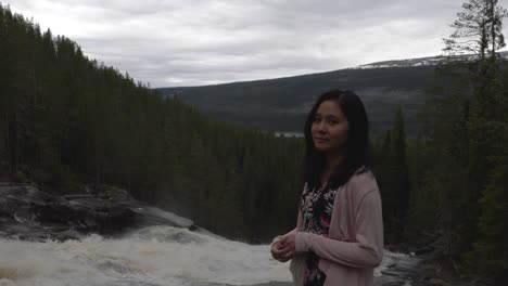 girl looking at waterfall in the forest