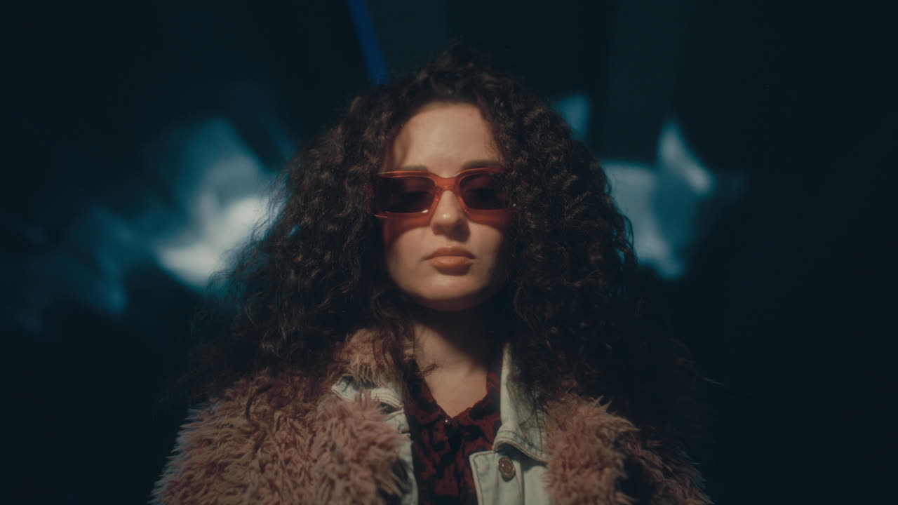 Portrait of Beautiful Girl in Stylish Outfit Standing in Dark Underpass