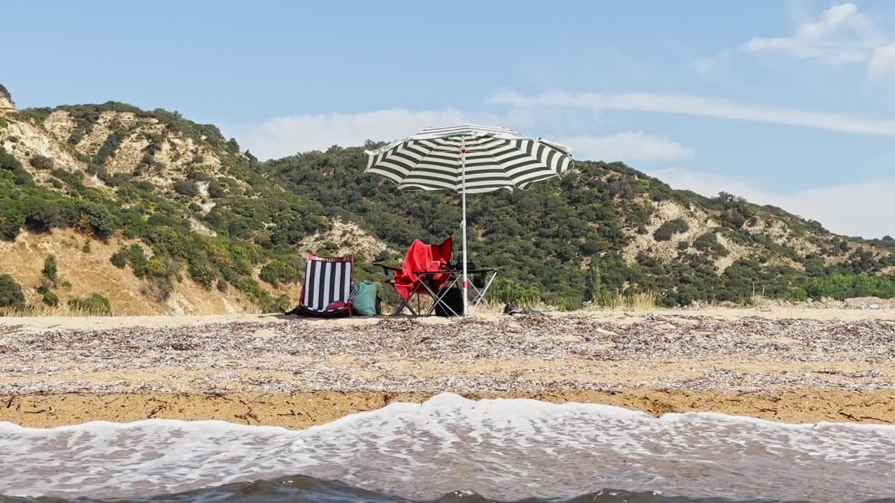 chairs and beach umbrellas on the sand at the seaside