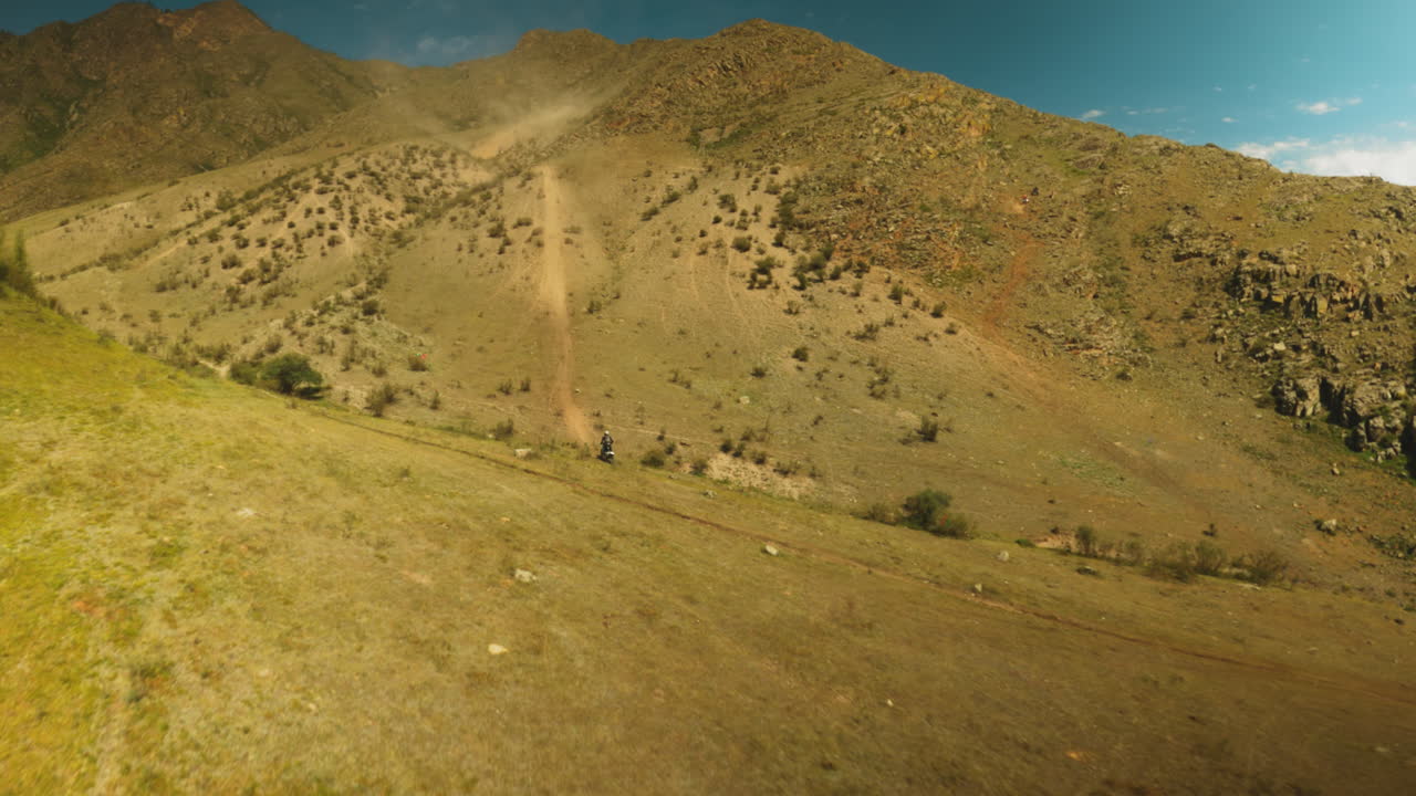 Professional rider conquers hills fpv drone. Skilled racer embodies adventurous spirit of sportspeople seeking thrill of motocross among nature grandeur