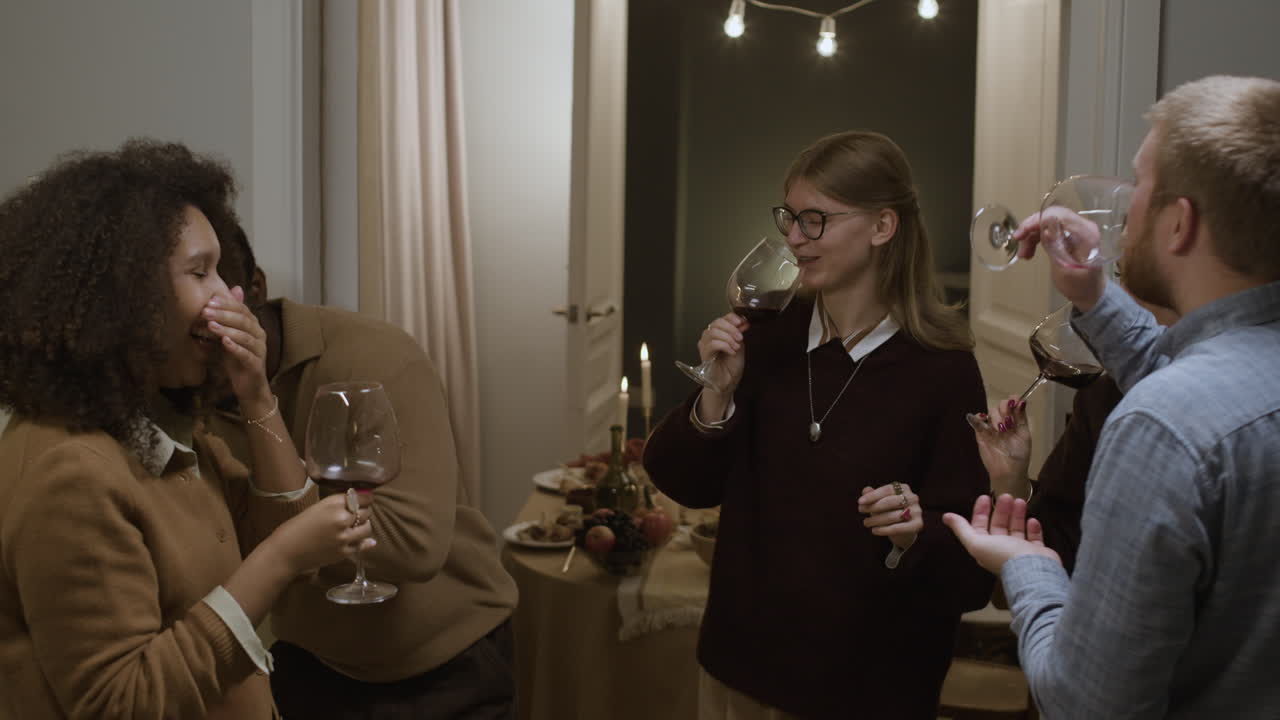 Friends toasting with wine glasses at a party