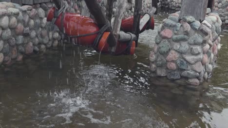 fuente de molino de agua con piedra y estructura de madera