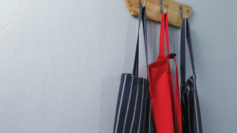 various aprons hanging on hook 4k