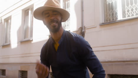 afro caribbean man has fun dancing salsa in the street