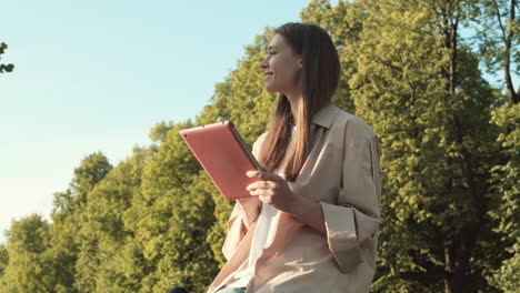 woman using tablet computer in park