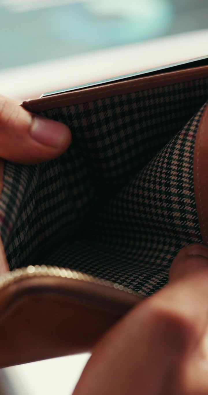 Person Opening and Checking an Empty Leather Wallet