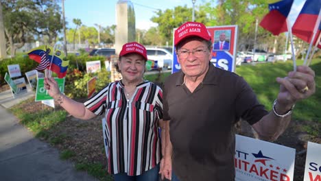 MAGA supporters of Donald Trump at the polls waving the US and Venezuelan flags in South Florida