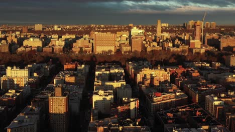 Golden-Hour-drone-flyover-of-Harlem-towards-Morningside-Heights-neighborhoods-of-Manhattan,-New-York-City