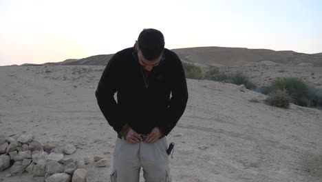 A-hiker-is-seen-smiling-after-zipping-up-his-trouser-and-tied-up-with-the-help-of-belt-in-the-Ramon-Crater