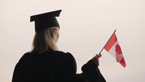 Rückansicht-Eines-Absolventen-Mit-Der-Flagge-Kanadas-In-Der-Hand-Studieren-In-Kanada