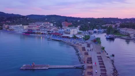 Greece,-Corfu-Island,-drone-footage-of-a-beautiful-sunset-over-Messonghi-Beach