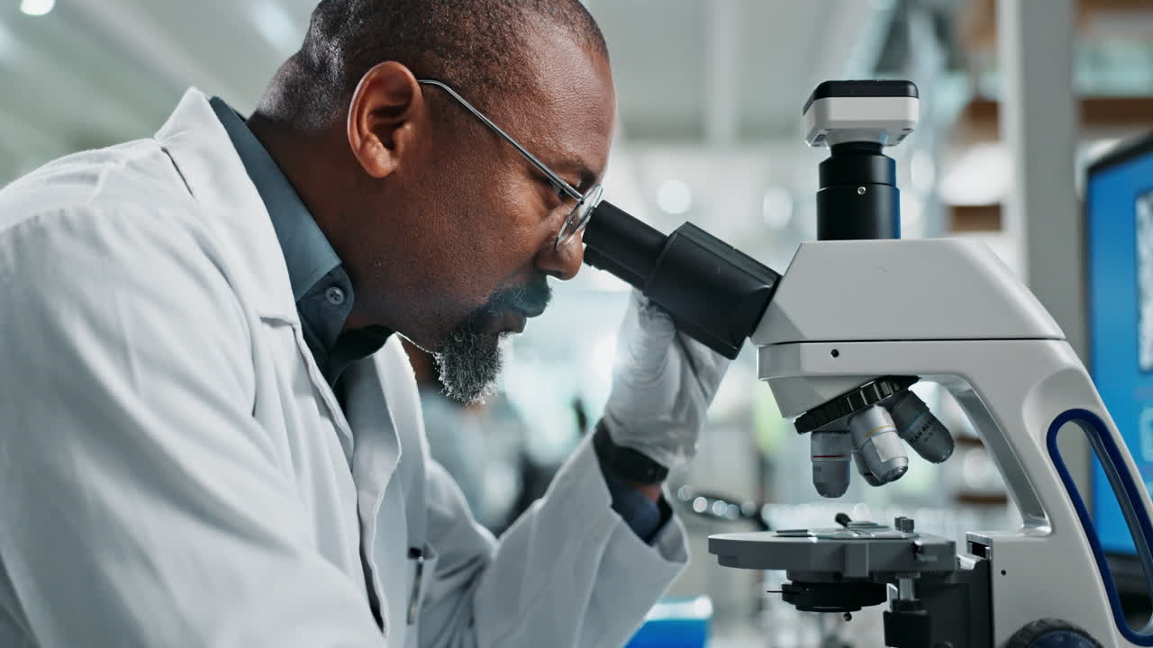 A scientist using a microscope in a laboratory