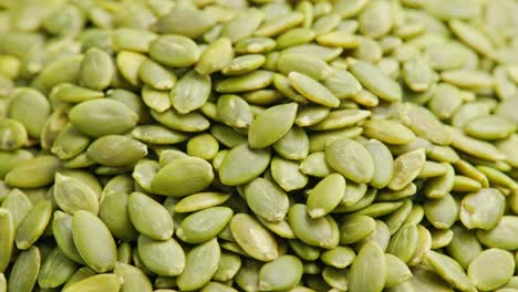 peeled pumpkin seeds full-frame spinning background