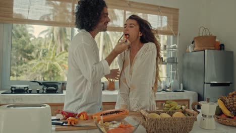 couple enjoying a fruitful breakfast/lunch/dinner in a tropical kitchen