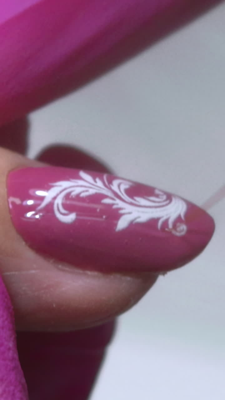 Closeup Caucasian Hand Applying Topcoat While Pink Gloved Technician Brushes Glossy Seal Over Mauve Polish. Media