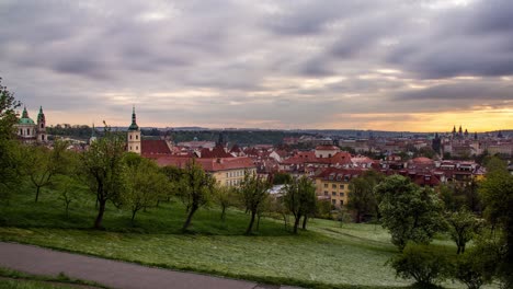 Sunrise-timelapse-of-Prague,-Czech-Republic-as-seen-from-the-orchards-of-Petřín-gardens-with-a-view-of-the-St