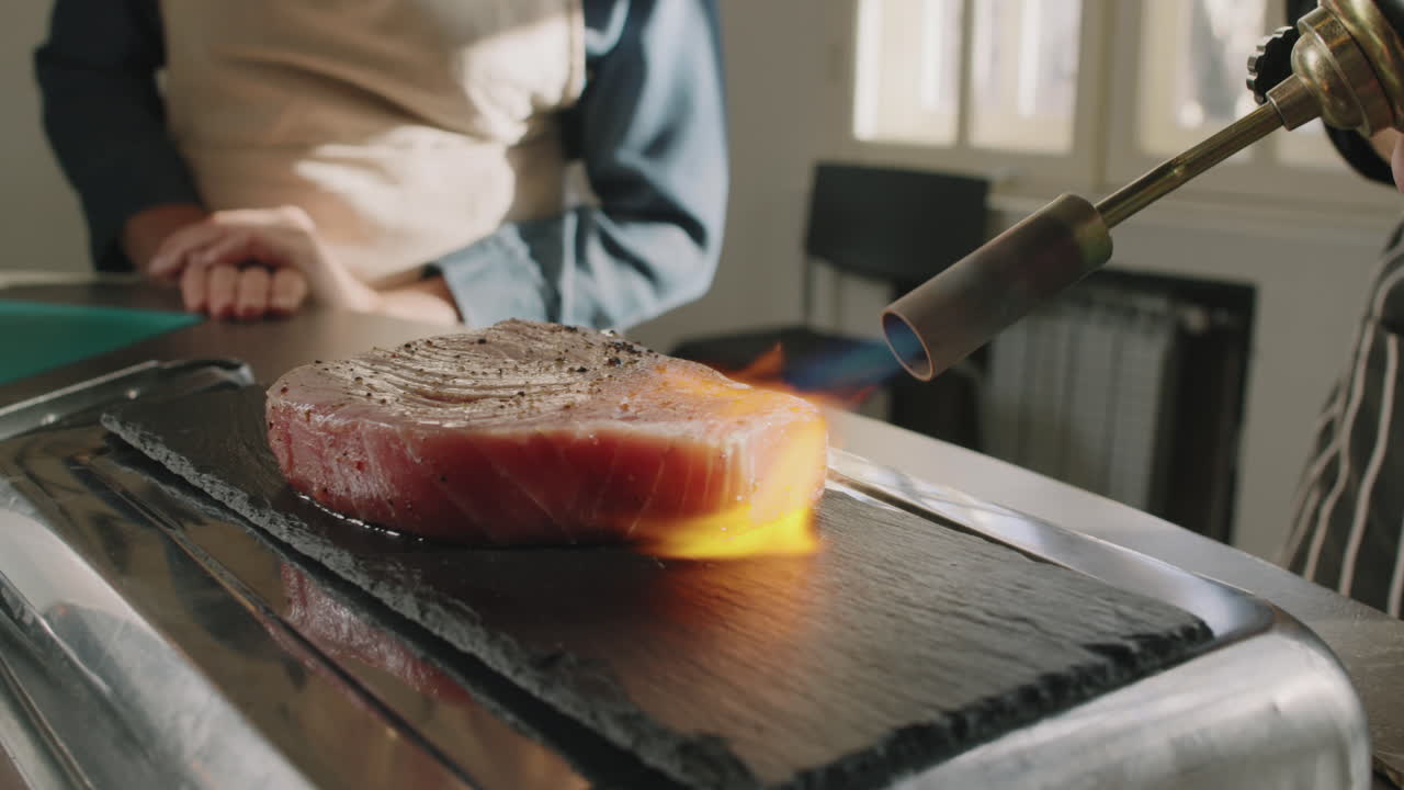Chef Searing Tuna Steak With Gas Torch