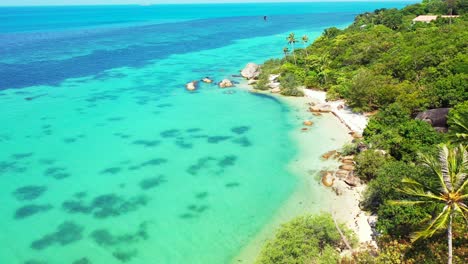 paradise exotic beach on a secret bay with calm turquoise lagoon washing white sand and old limestone cliffs of coastline in thailand