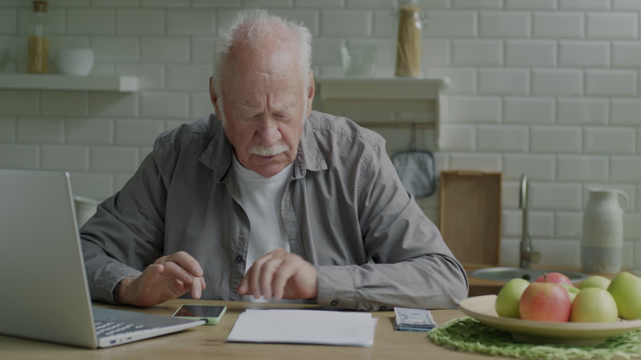 Elderly Man Paying Bills