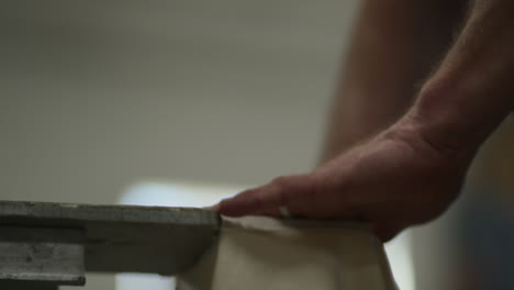 man places t shirt pocket on screen printing machine