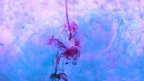 4k footage of colorful ink drops in water, isolated abstract background. pouring ink in water. underwater paint mix. slow psychedelic dye swirls, colored smoke explosion. splashing, floating liquid