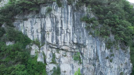 View-of-drone-moving-towards-the-back-of-an-impressive-rock-climbing-site-in-the-town-of-lierganes,-cantabria