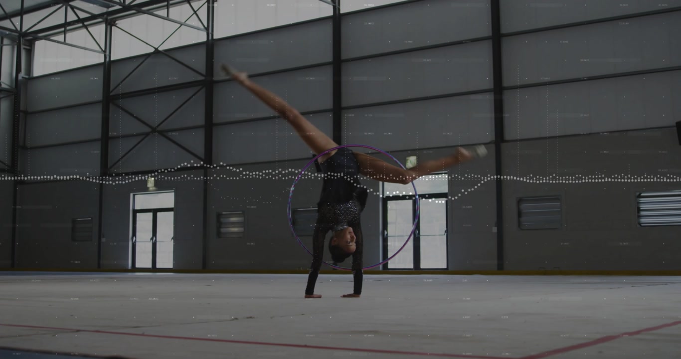 Woman gymnast nearing hoop, rolling, leaping through, tumbling, waveform syncing, finishing routine