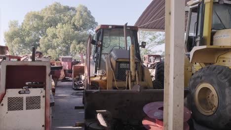 yellow bulldozer and other heavy machinery in a repair shop