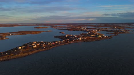 aerial view of an arctic coastal village at sunset