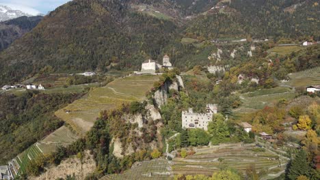 aerial drone over a medieval castle in the middle of the vineyards in italy