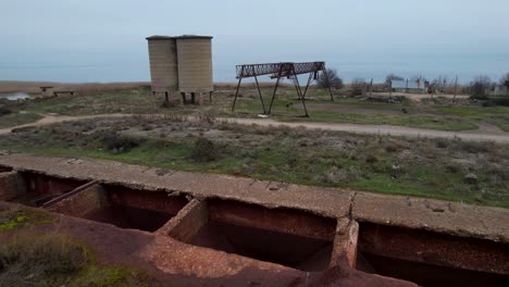 site of the loading of ore by crane into the wagons of the freight train and the ruins of machinery from the time of state enterprises in albania