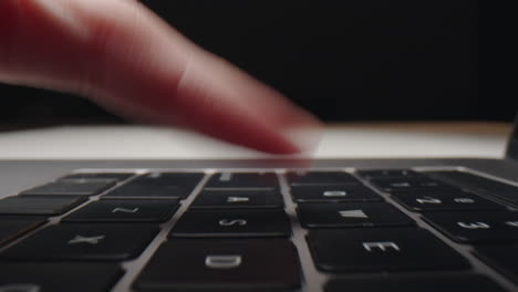 Person Typing on a Laptop Keyboard