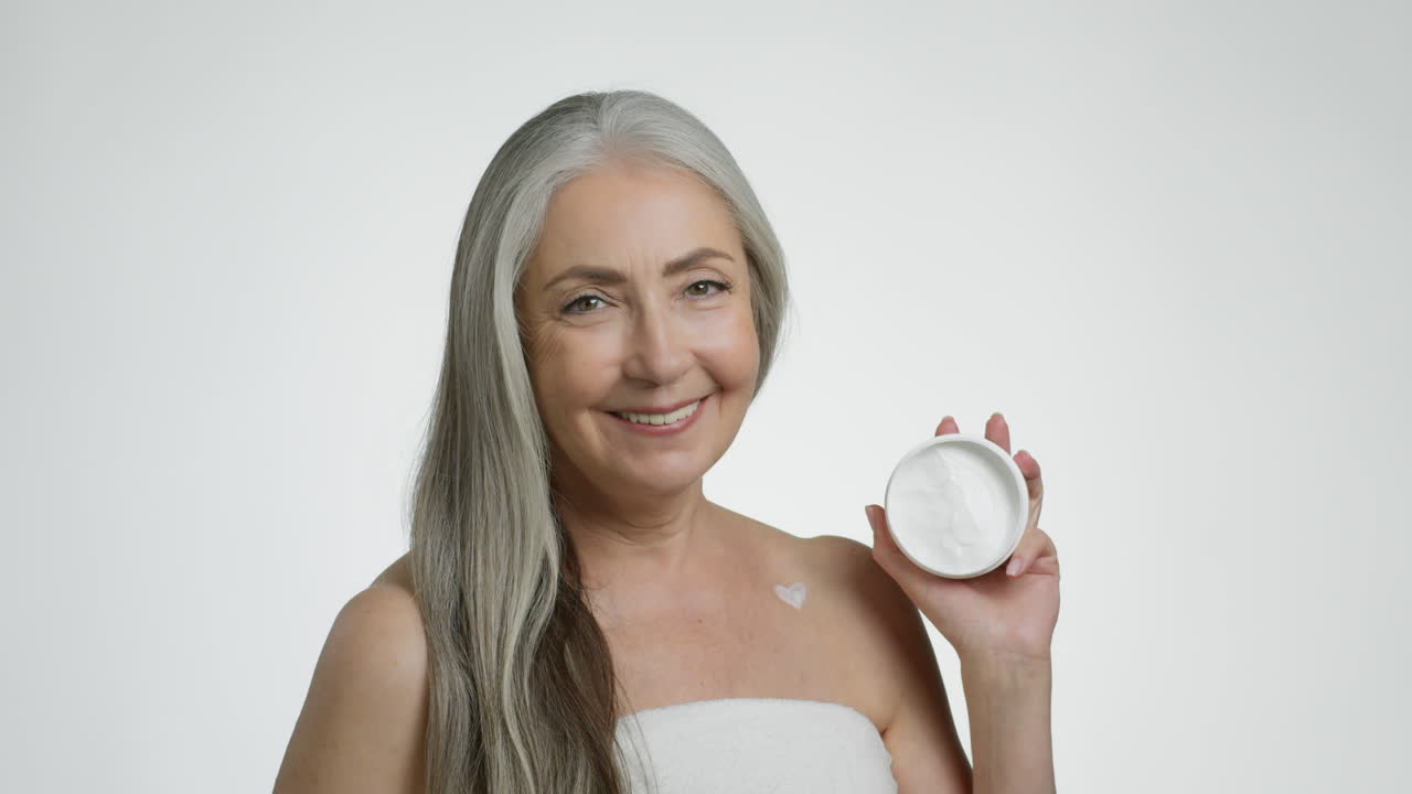 Senior Woman Holding a Jar of Cream