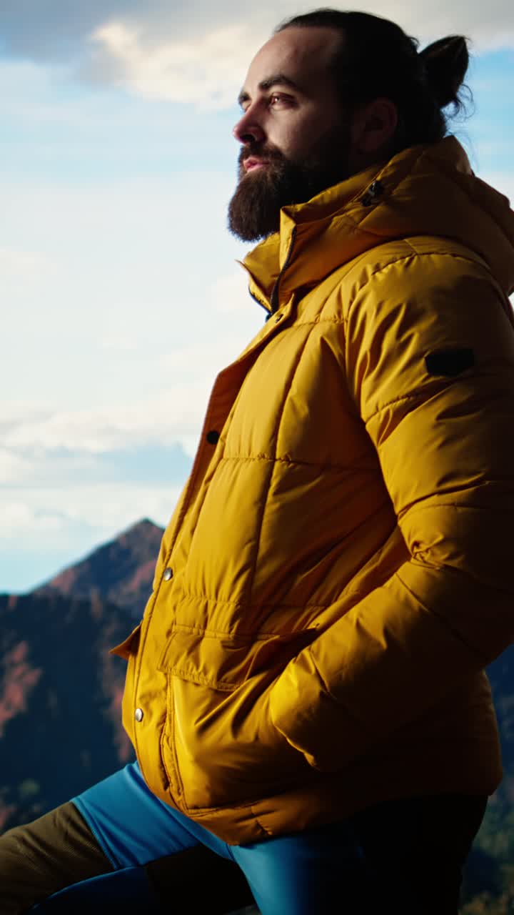 Bearded Man in Yellow Puffer Jacket Gazing at Mountain View