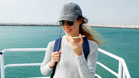 Woman-talking-on-mobile-phone-while-travelling-in-ferry-4k