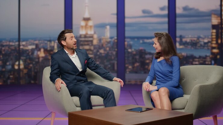 Living talk show tv channel at modern studio. Young anchorwoman asking guest