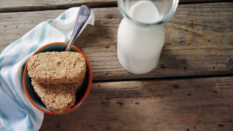 granola bar and milk on a wooden table 4k