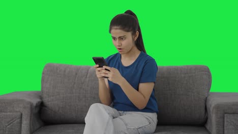 Angry-Indian-teenage-girl-chatting-with-someone-Green-screen