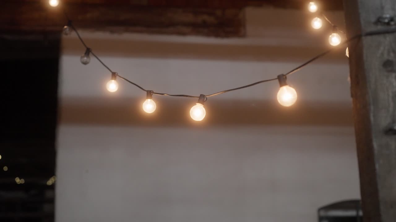 A string of light bulbs serving as decoration and lighting at night